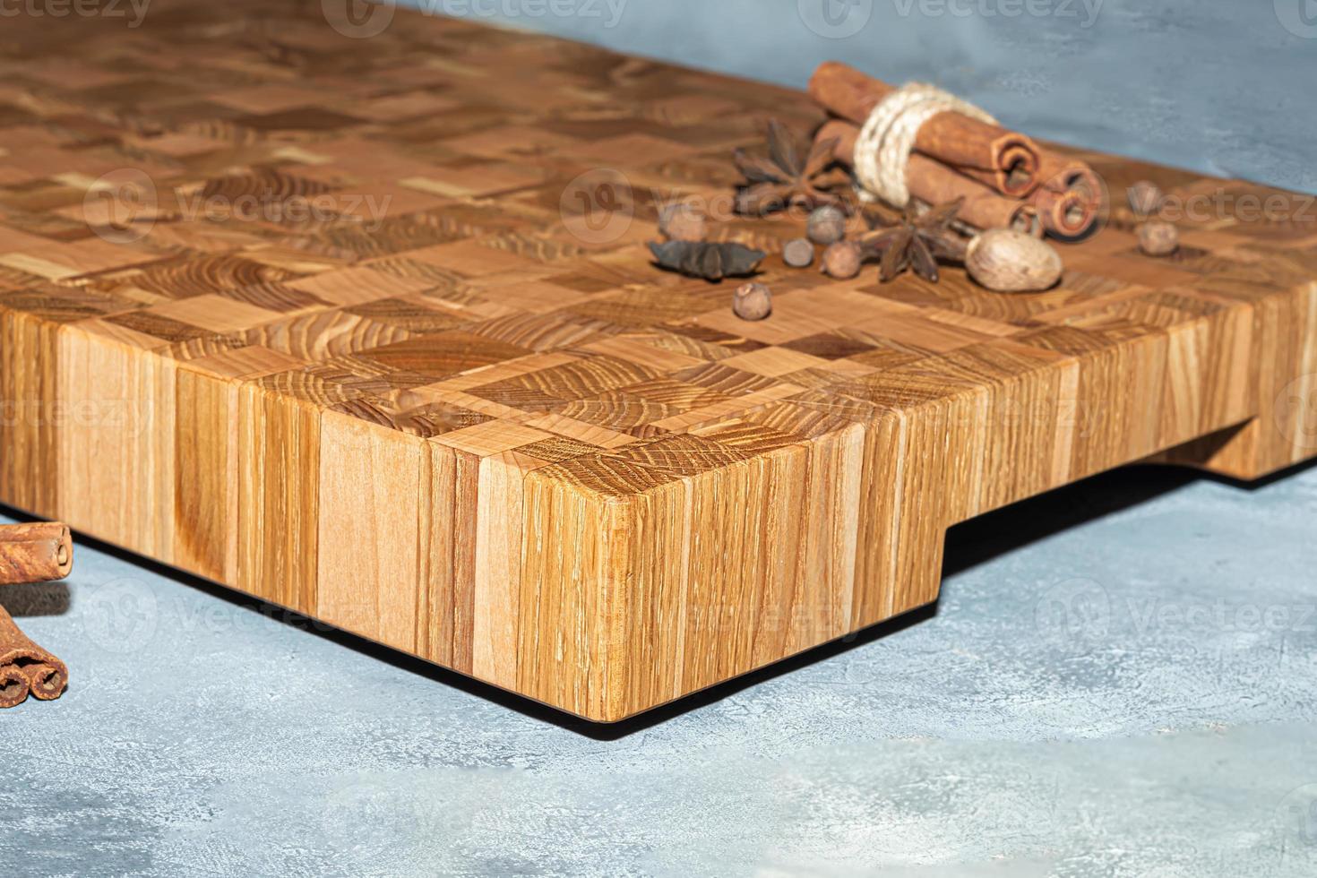 Wooden board for cutting handmade products with chopped vegetables. On a light background. photo