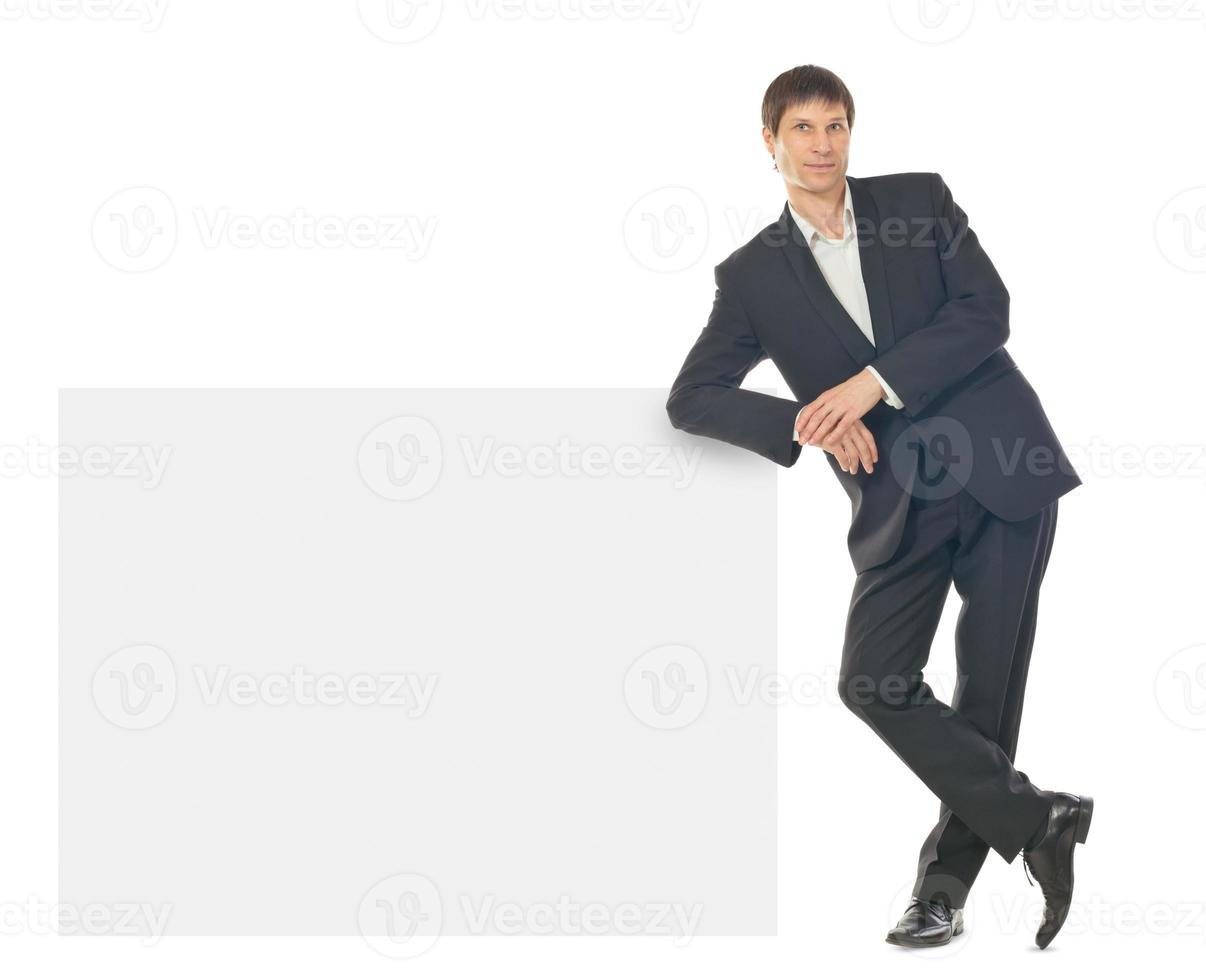 Portrait of young business man showing blank signboard photo