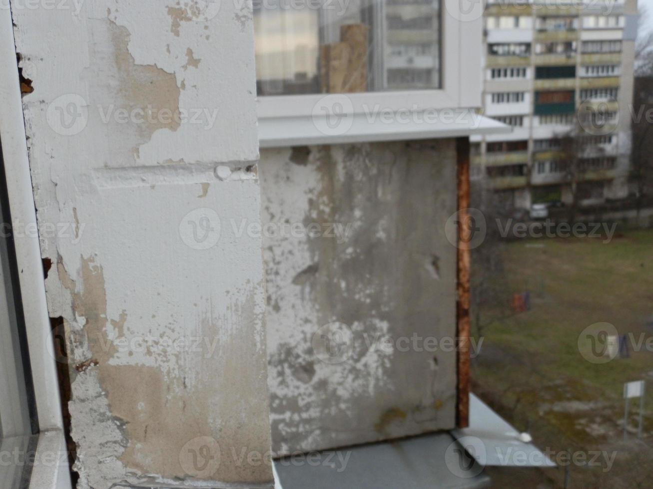 Old cracked balcony railing slab in need of repair photo