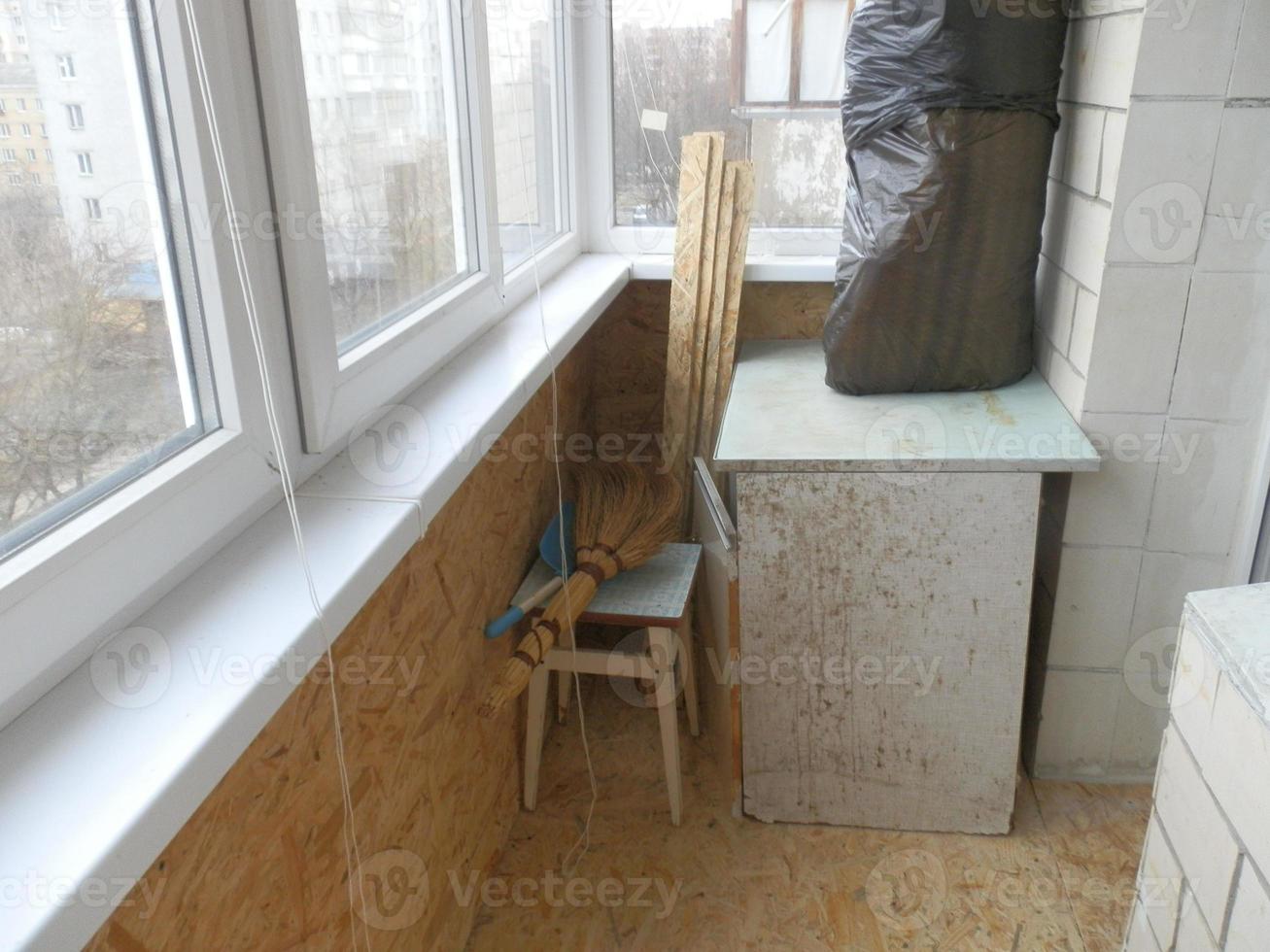 Warming and cladding with slabs of a balcony in an apartment house photo