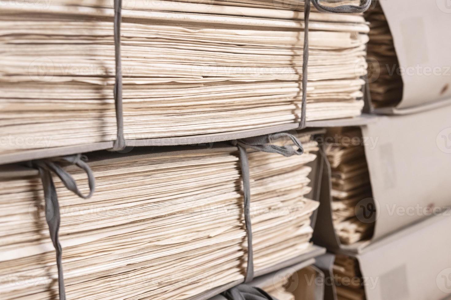 Old files stacked in folders background. Stacks of weathered working Paper documents photo