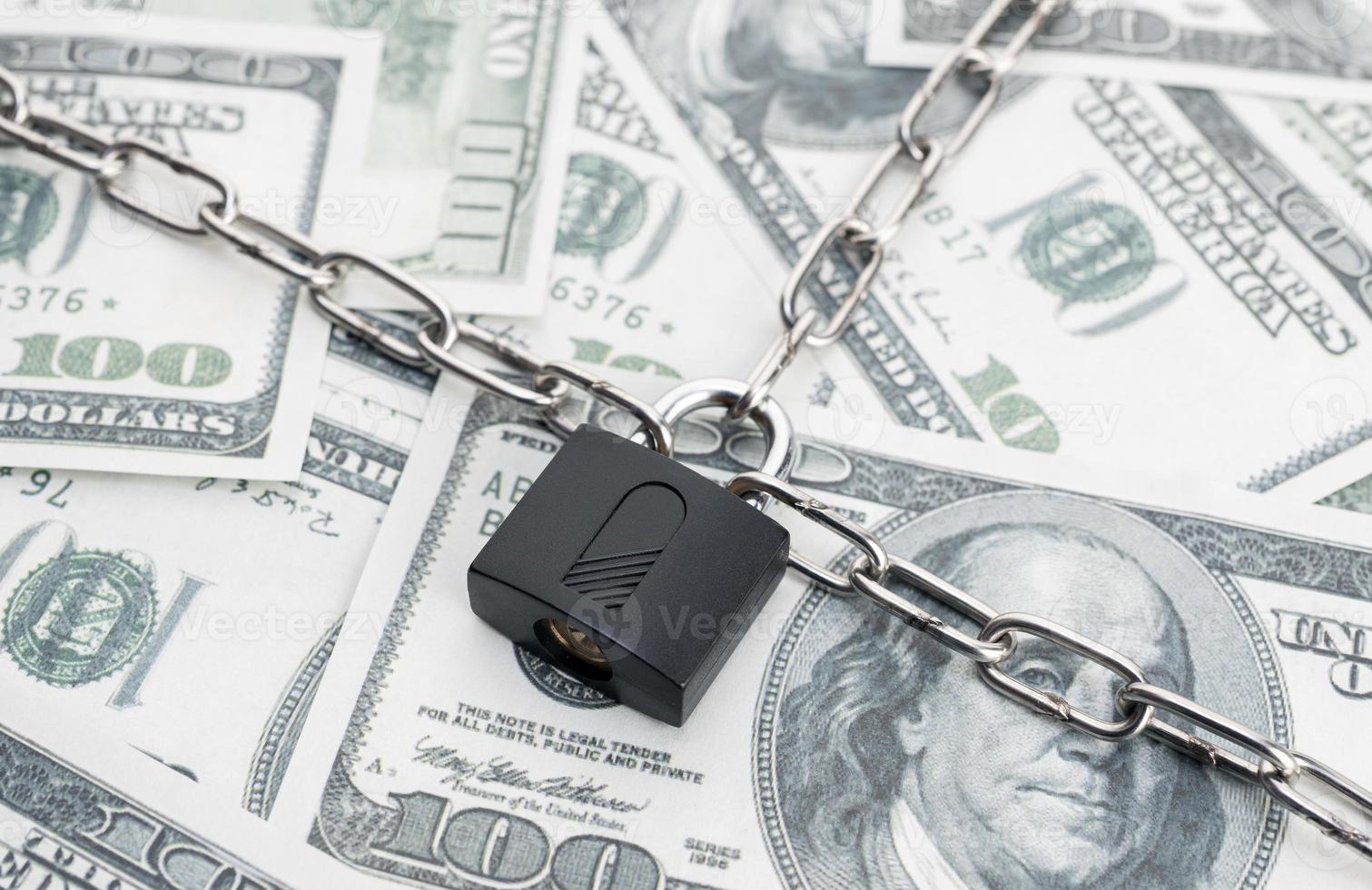 Lock security and chain on dollar banknotes background. Monetary crisis, financial problems, sanctions, default concept photo