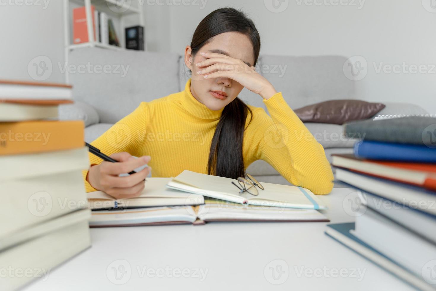 Asian student woman have anxiety because of exams, female prepare for test and learning lessons in the library. stress, despair, haste, misunderstanding reading, discouraged, expectation, knowledge photo