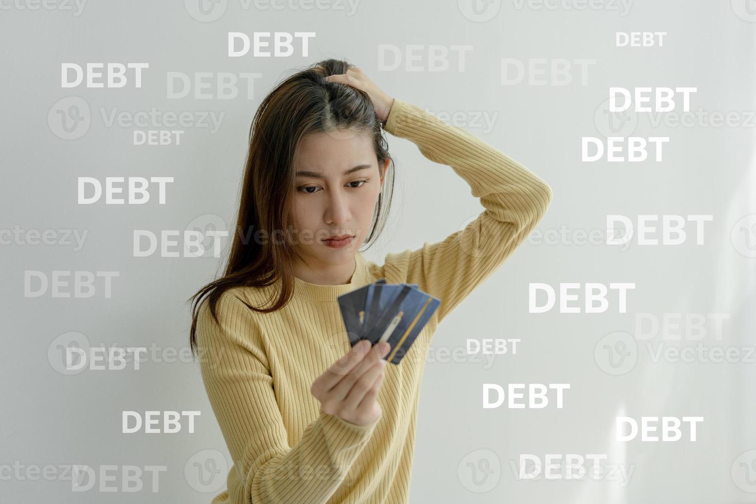 Stressed and headache asian woman with large bills or invoices no money to pay to expenses and credit card debt. shortage, Financial problems, mortgage, loan, bankruptcy, bankrupt, poor, empty wallet photo