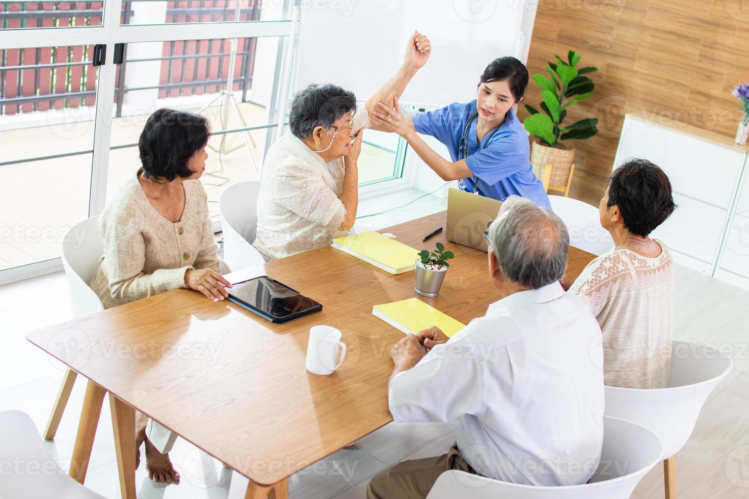 Nursing Home Care concept. A group of elderly people in nursing homes meeting with nursing care assistants photo