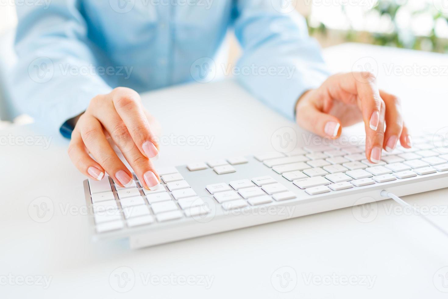 Woman office worker typing on the keyboard photo