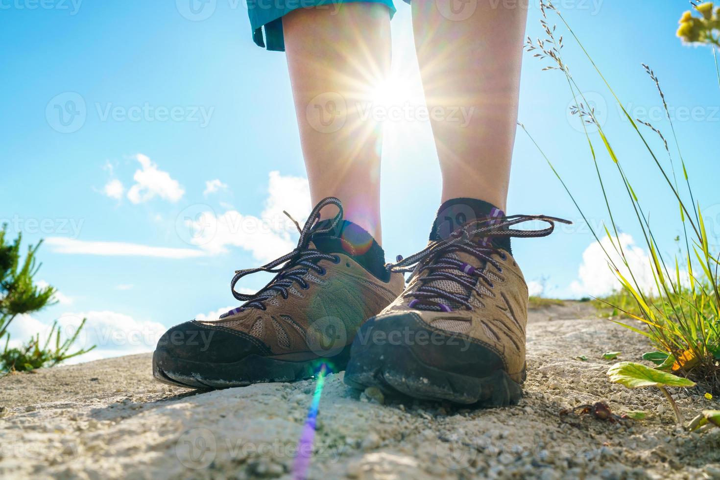 Legs of woman in tourist boots close-up. Hiking photo