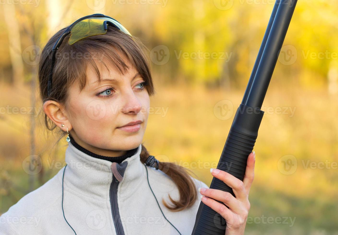 Young beautiful girl with a shotgun photo