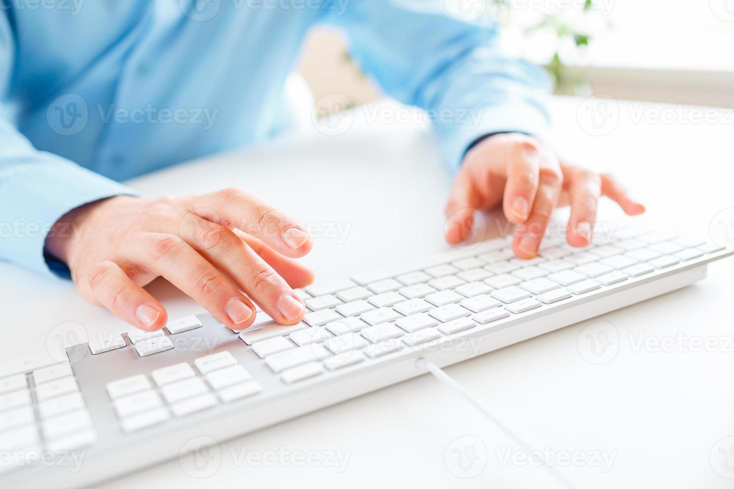 Men office worker typing on the keyboard photo