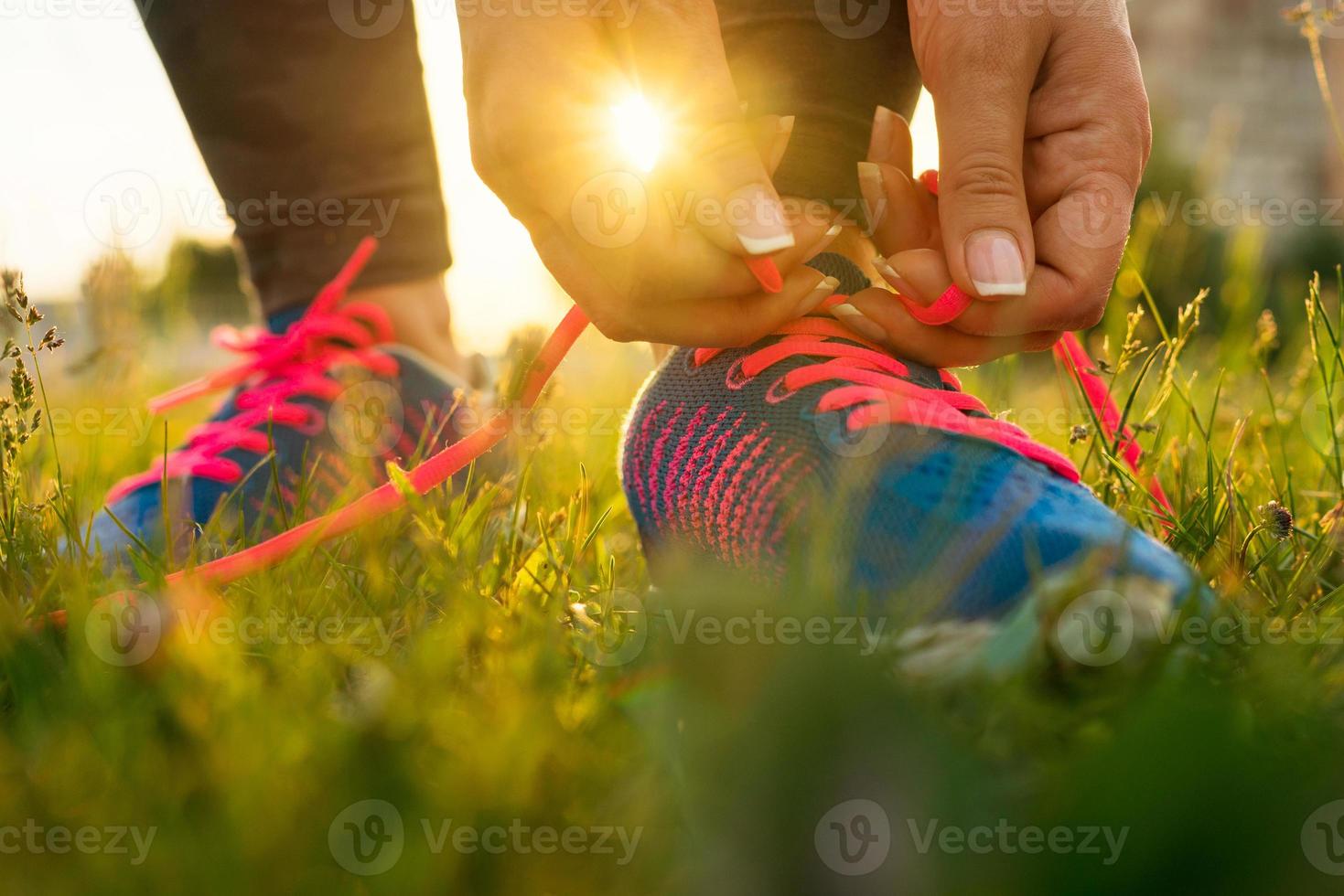 Running shoes - woman tying shoe laces photo