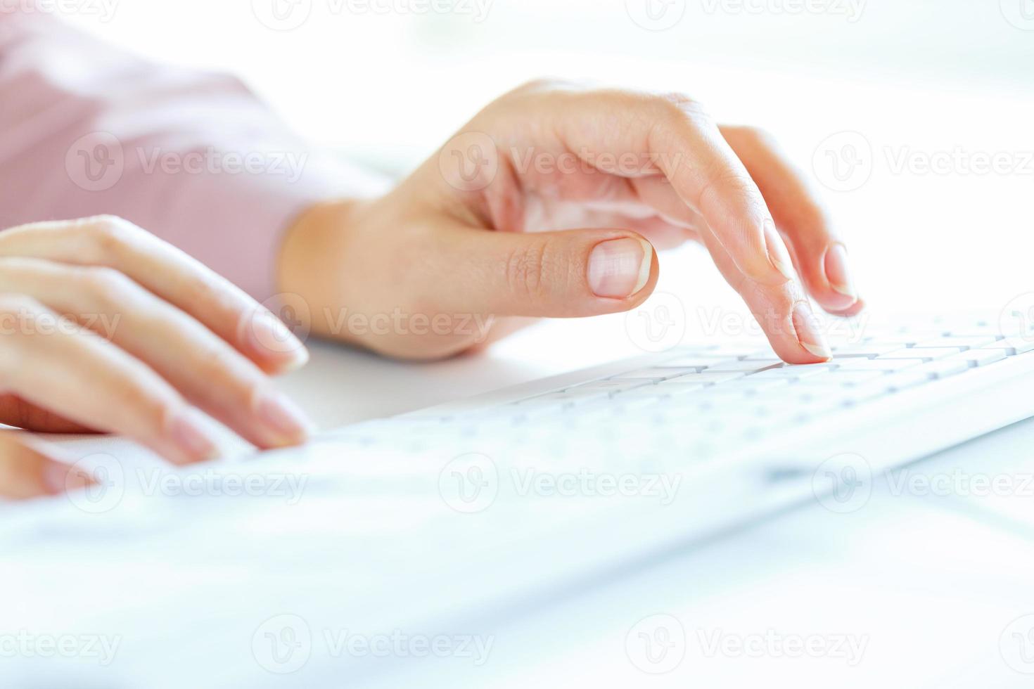 Woman office worker typing on the keyboard photo