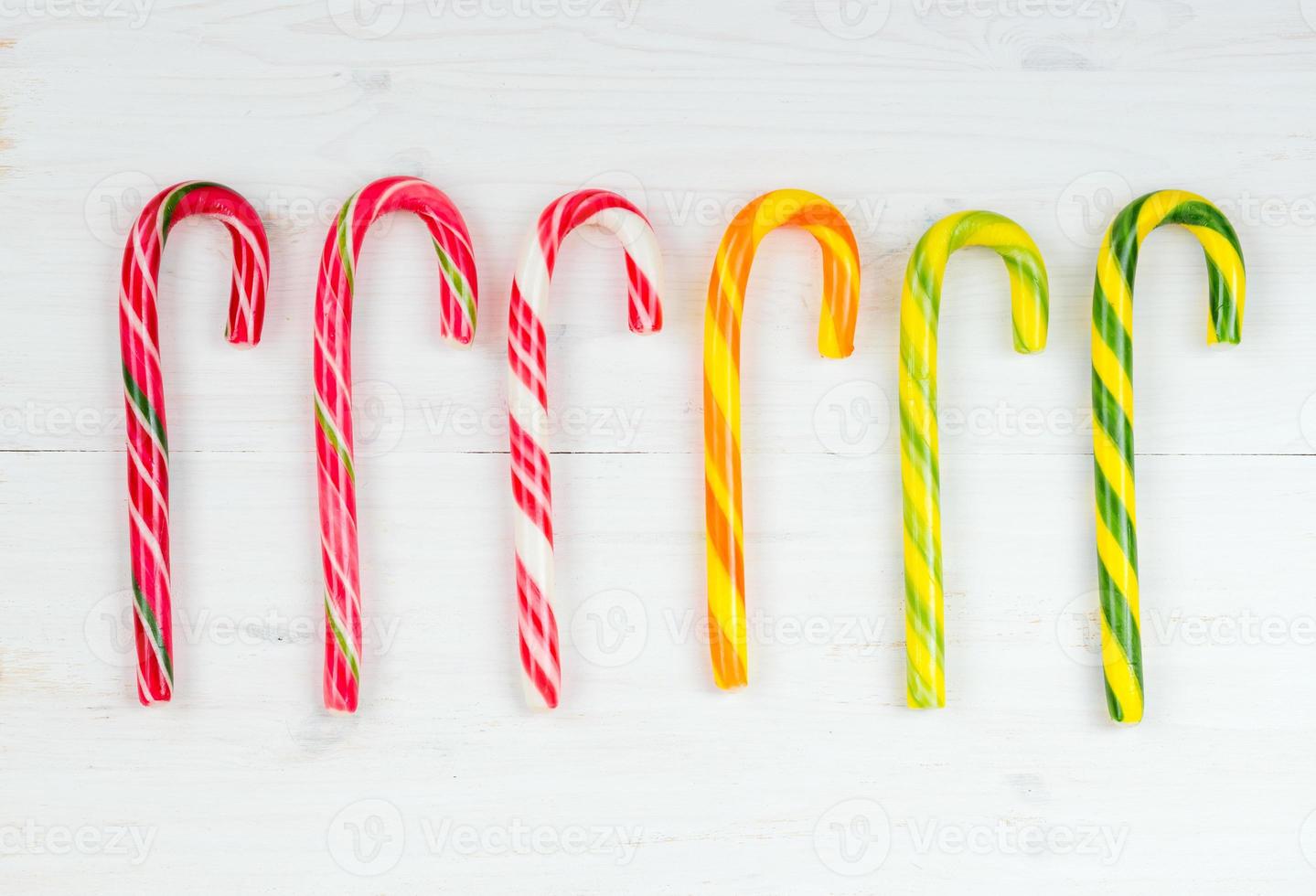 Christmas candy cane on a white wooden background photo