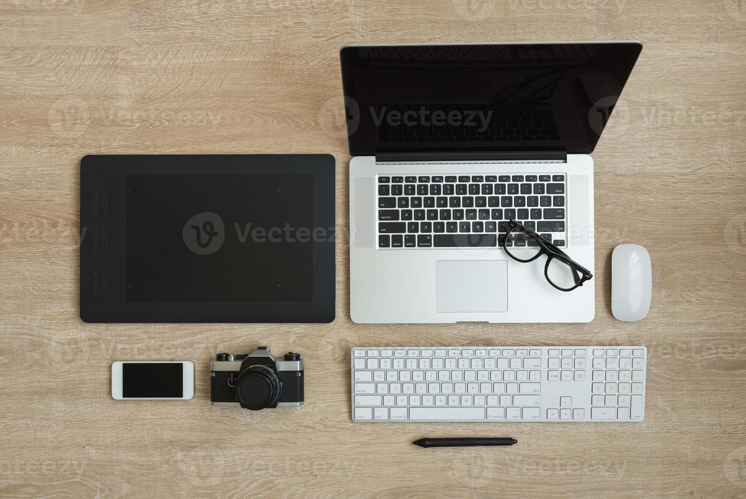 Top view of business workplace with laptop and gadgets photo