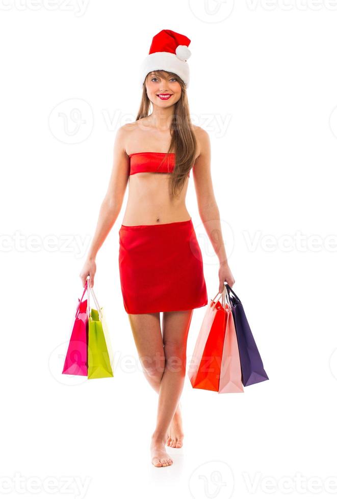 Beautiful Santa christmas girl with shopping bags on white photo