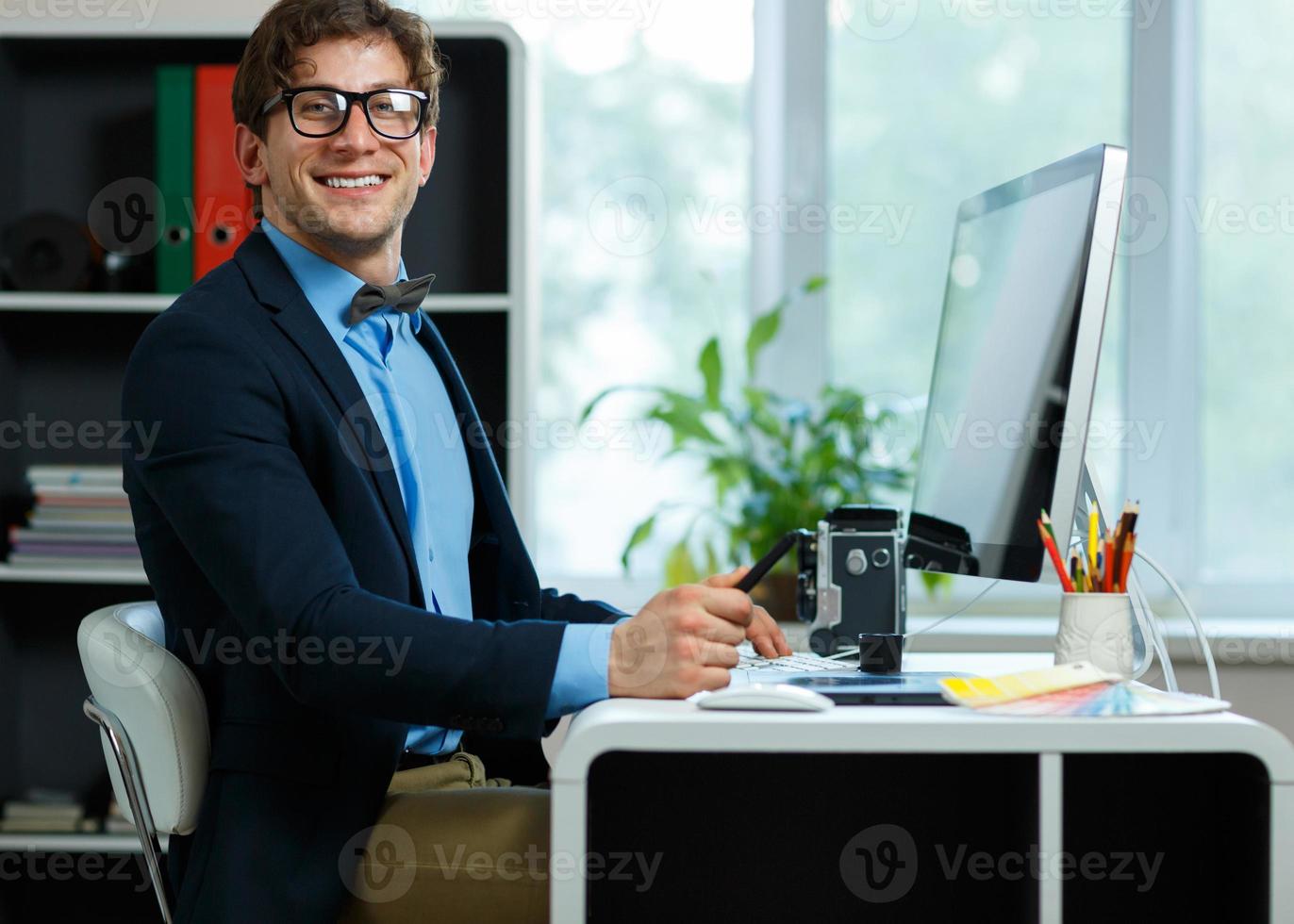 Handsome young man working from home office photo