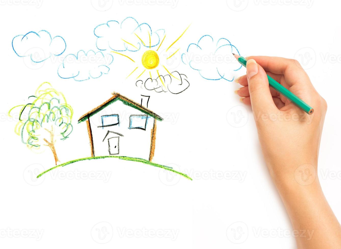 woman's hand drawing the dream home photo