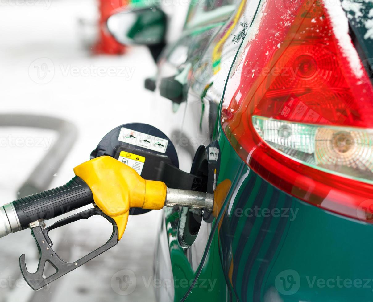 Car refueling on a petrol station in winter photo