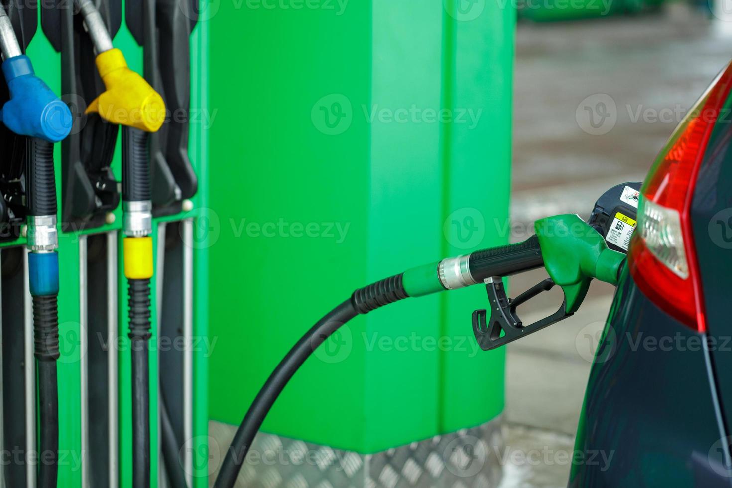 Car refueling on a petrol station in winter close up photo