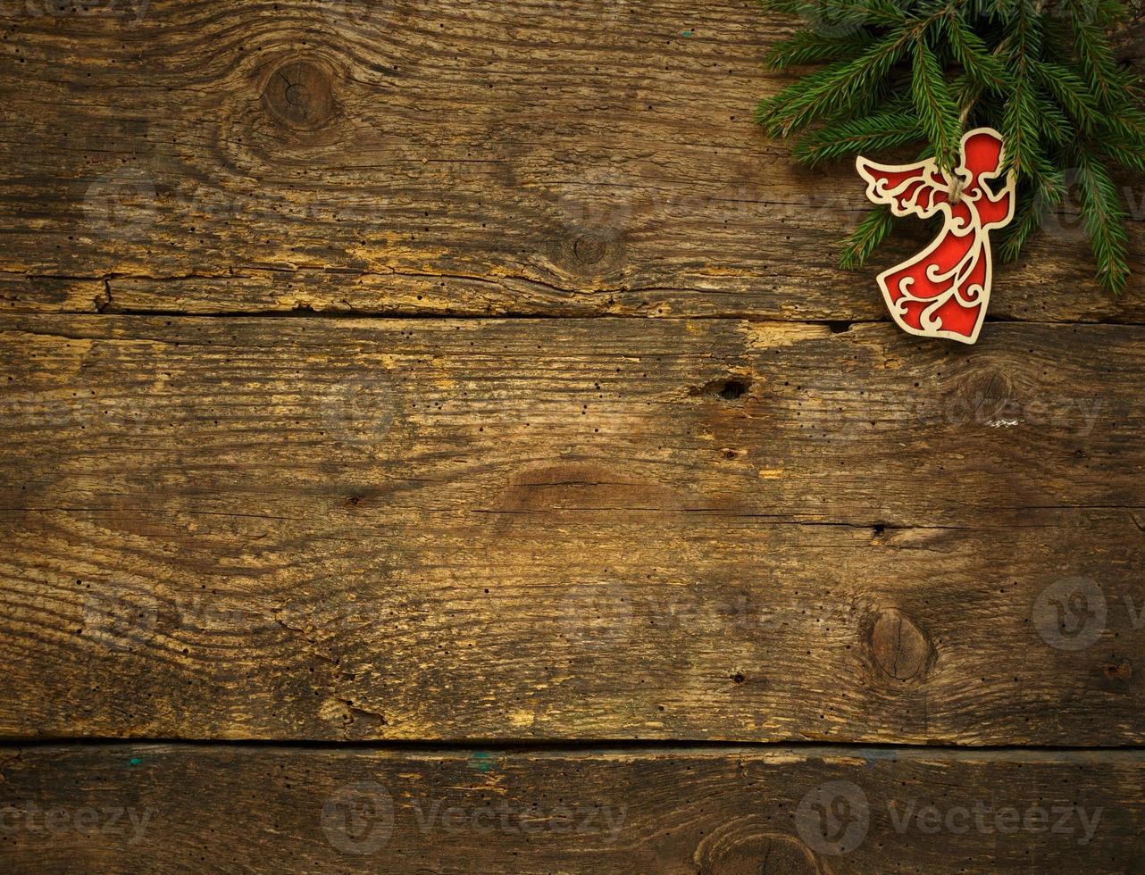 Christmas tree branches with cones and christmas decorations on wooden texture ready for your design photo