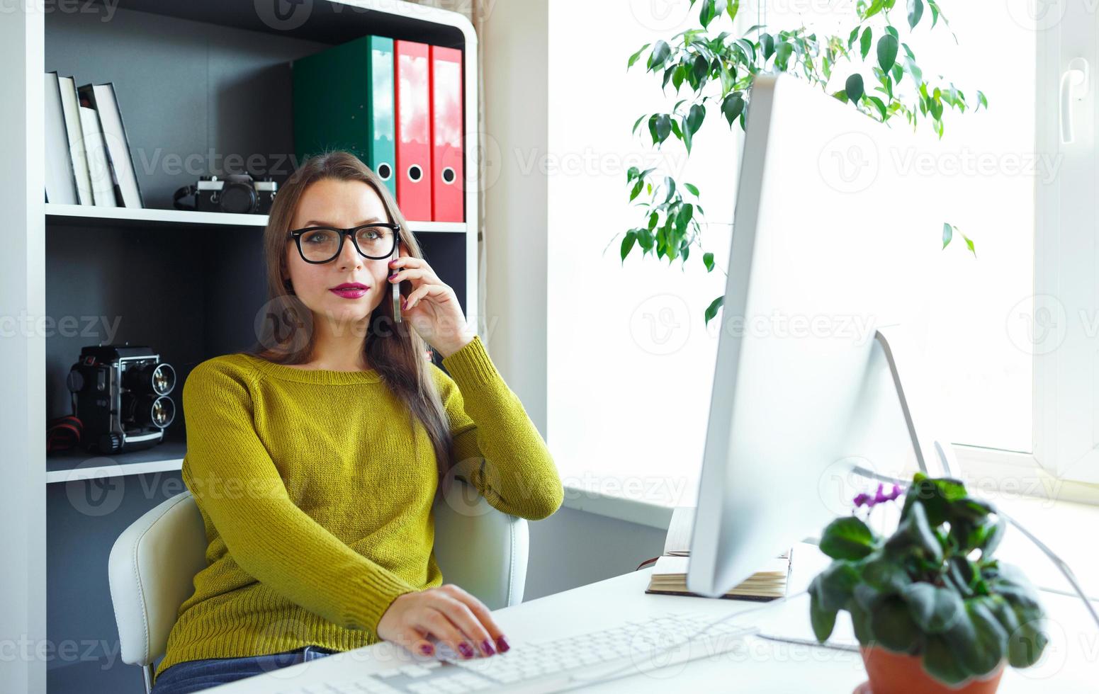 Young woman working from home - modern business concept photo