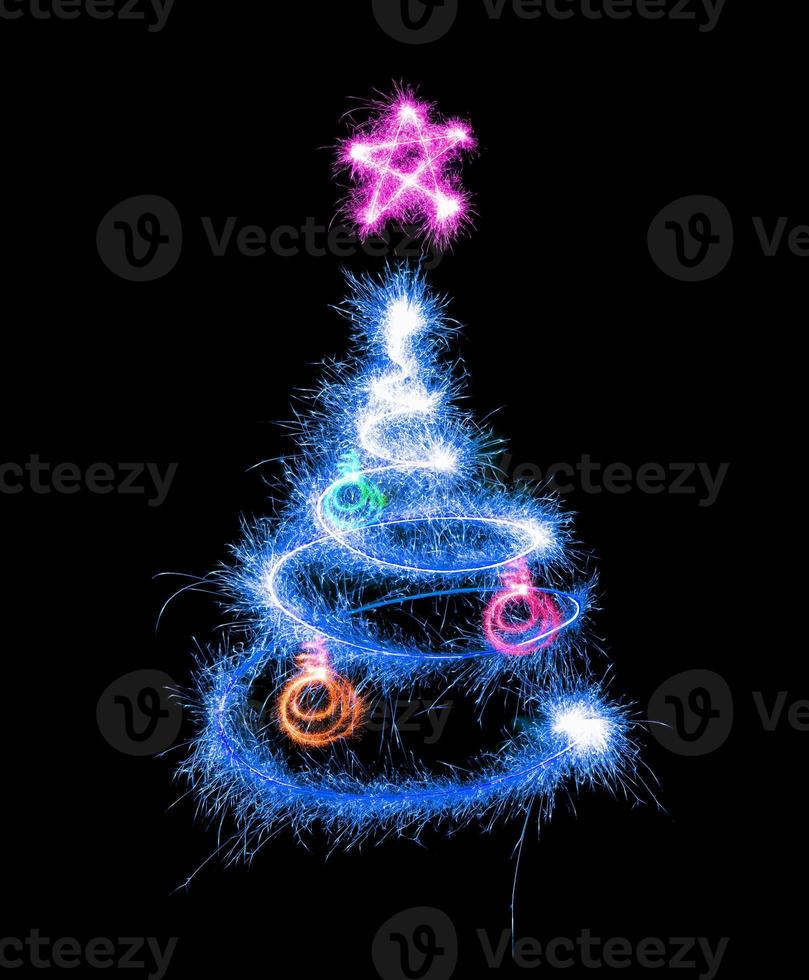 Christmas tree made by sparkler on a black photo