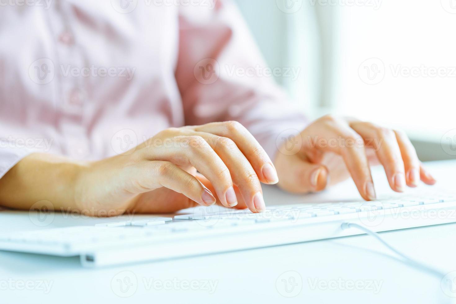 Woman office worker typing on the keyboard photo