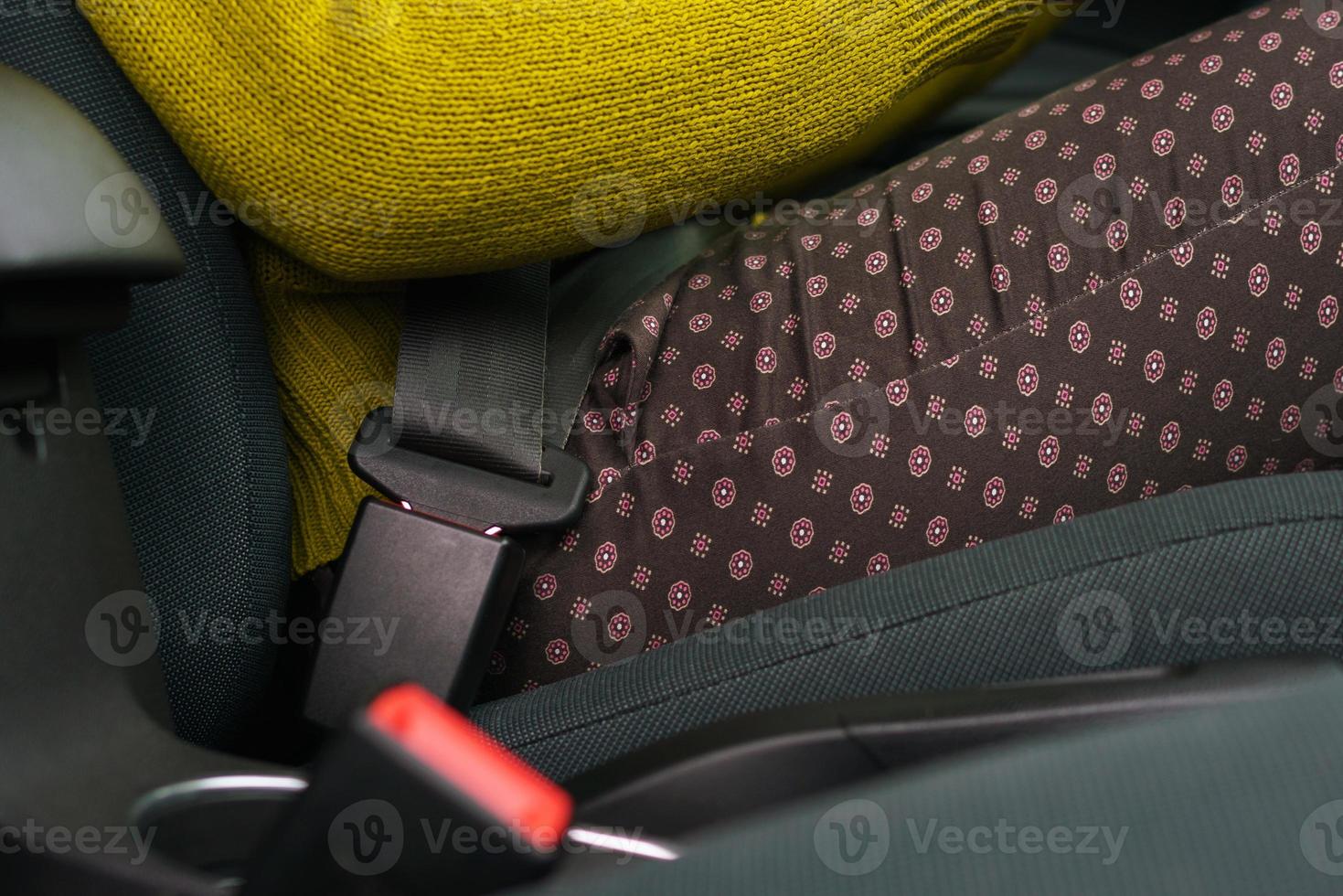 Woman fastening car safety seat belt while sitting inside of vehicle before driving photo