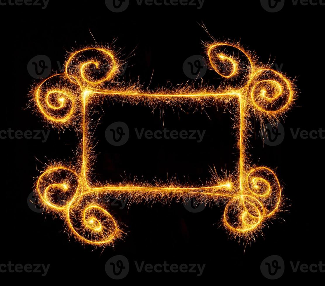 Frame made with sparklers ready for your inscriptions on black photo
