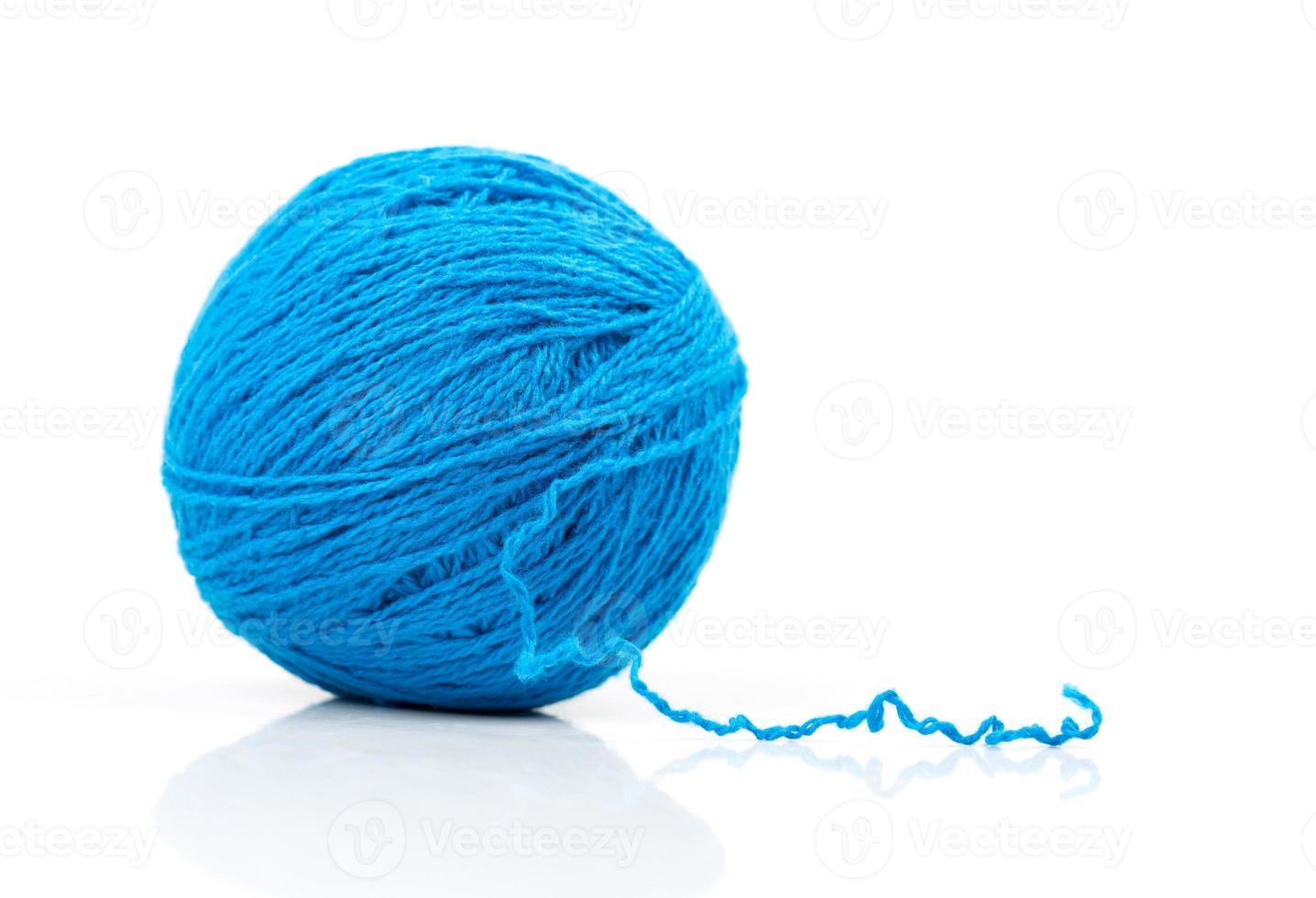 Blue ball of yarn on white photo