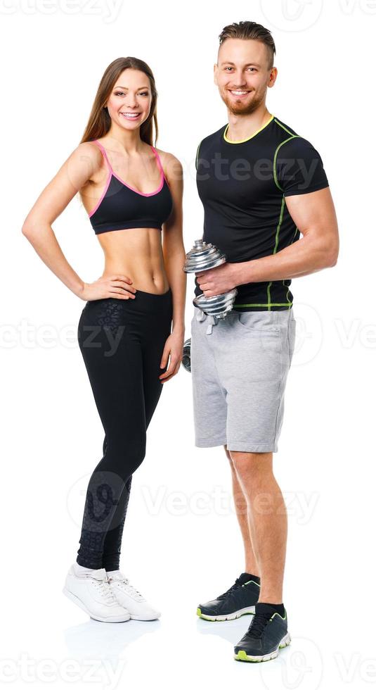 Athletic man and woman with dumbbells on the white photo