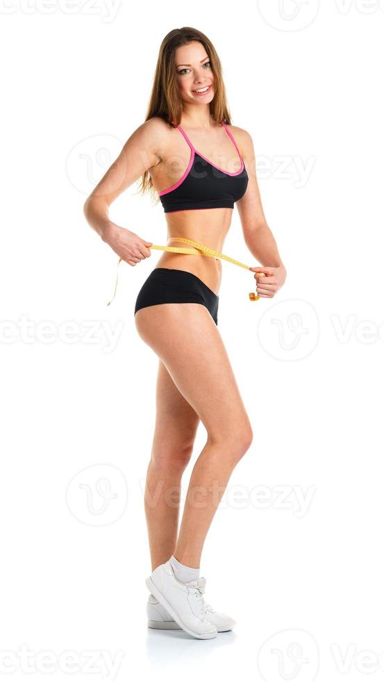 Woman measuring perfect shape of beautiful waist, healthy lifestyles concept photo