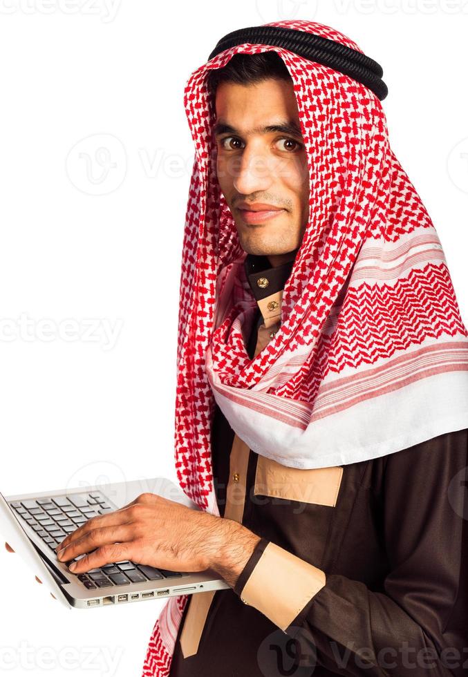 Young smiling arab with laptop isolated on white photo