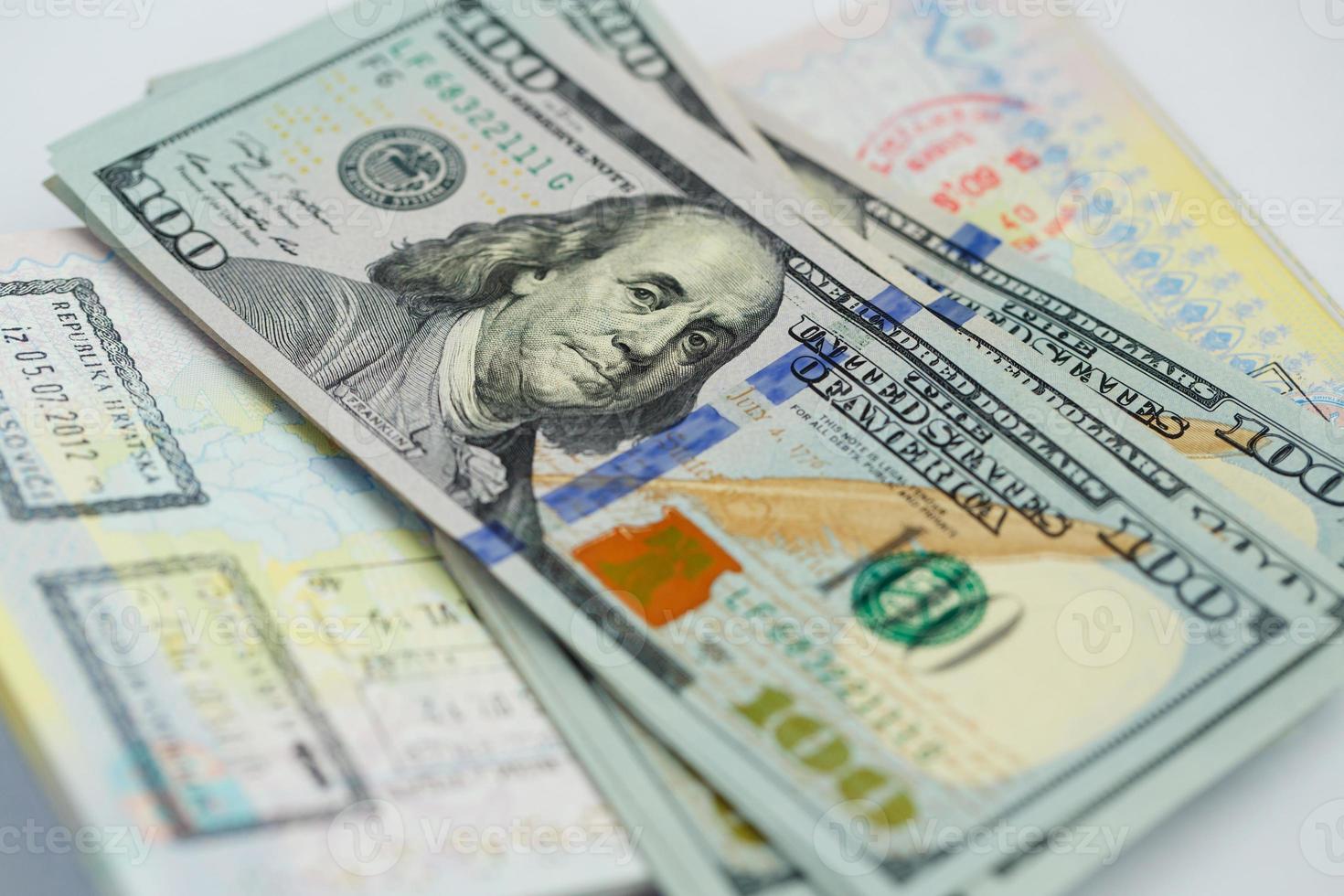 American money is on the top of the opened passport photo