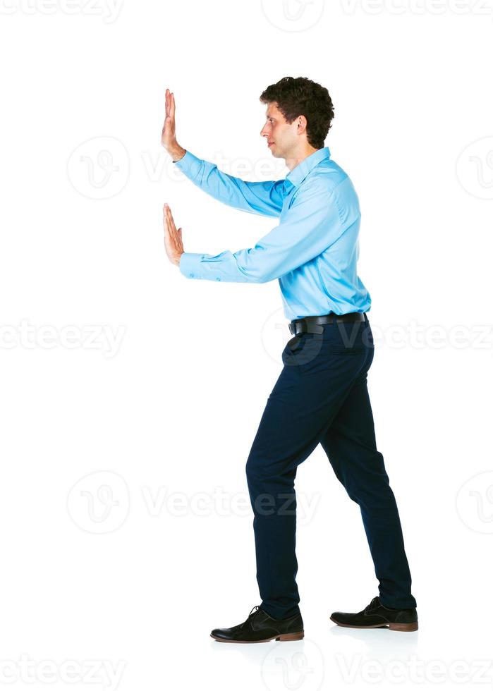 Young businessman pushing a alleged blank billboard on white photo