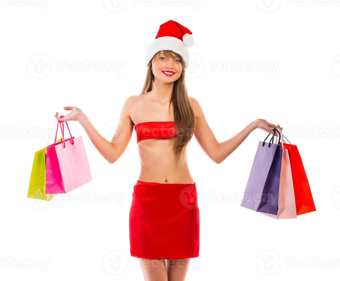 Beautiful Santa christmas girl with shopping bags on white photo