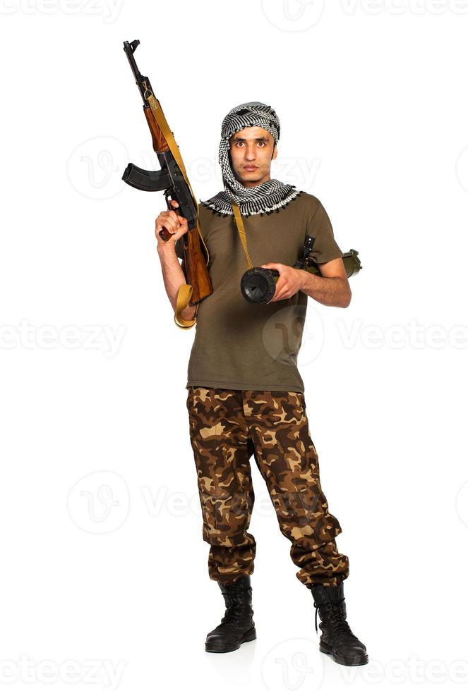 Arab nationality in camouflage suit and keffiyeh with automatic gun and launcher on white background photo