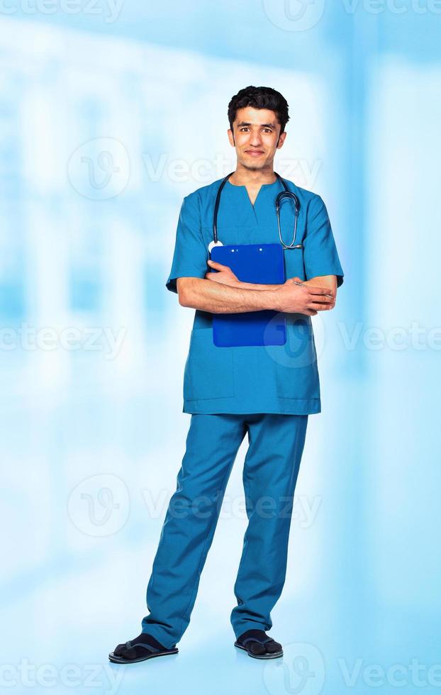 Portrait of the smiling arab doctor on interior photo