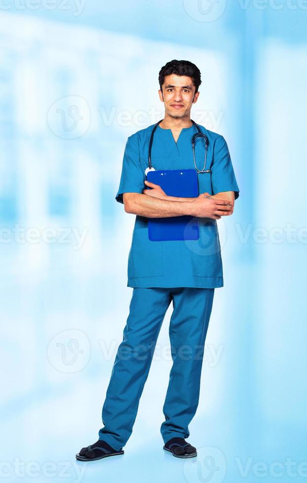 Portrait of the smiling arab doctor on interior photo