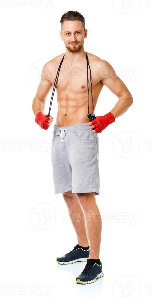 Athletic attractive man with a rope on the white photo