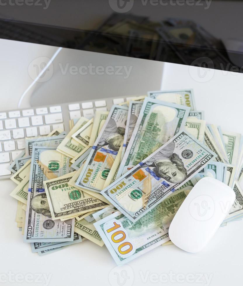 Dollar bills on the white computer keyboard photo