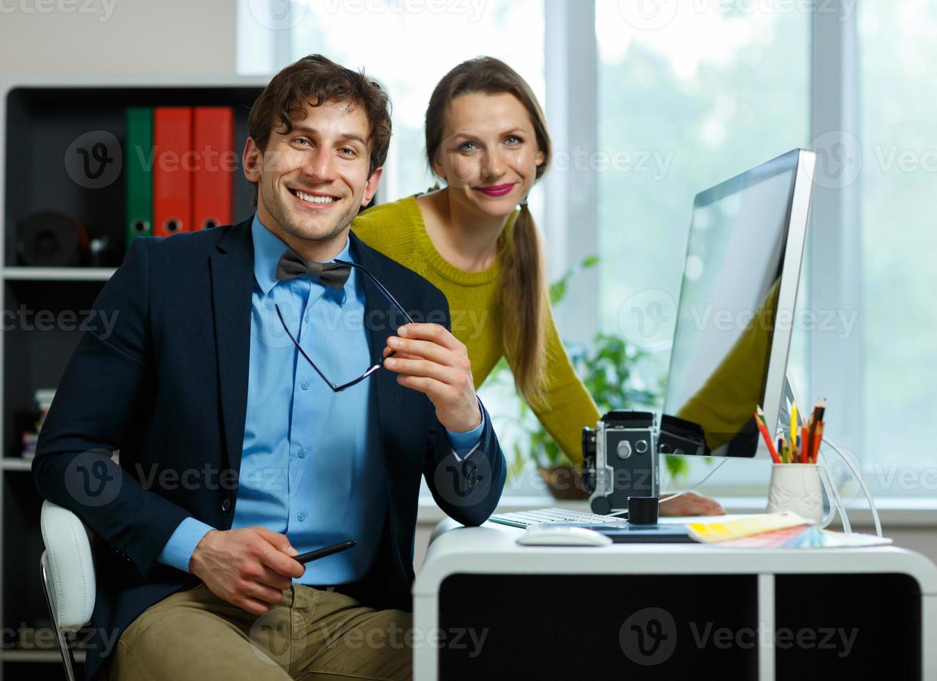 Young colleague - man and woman working from home - modern business concept photo