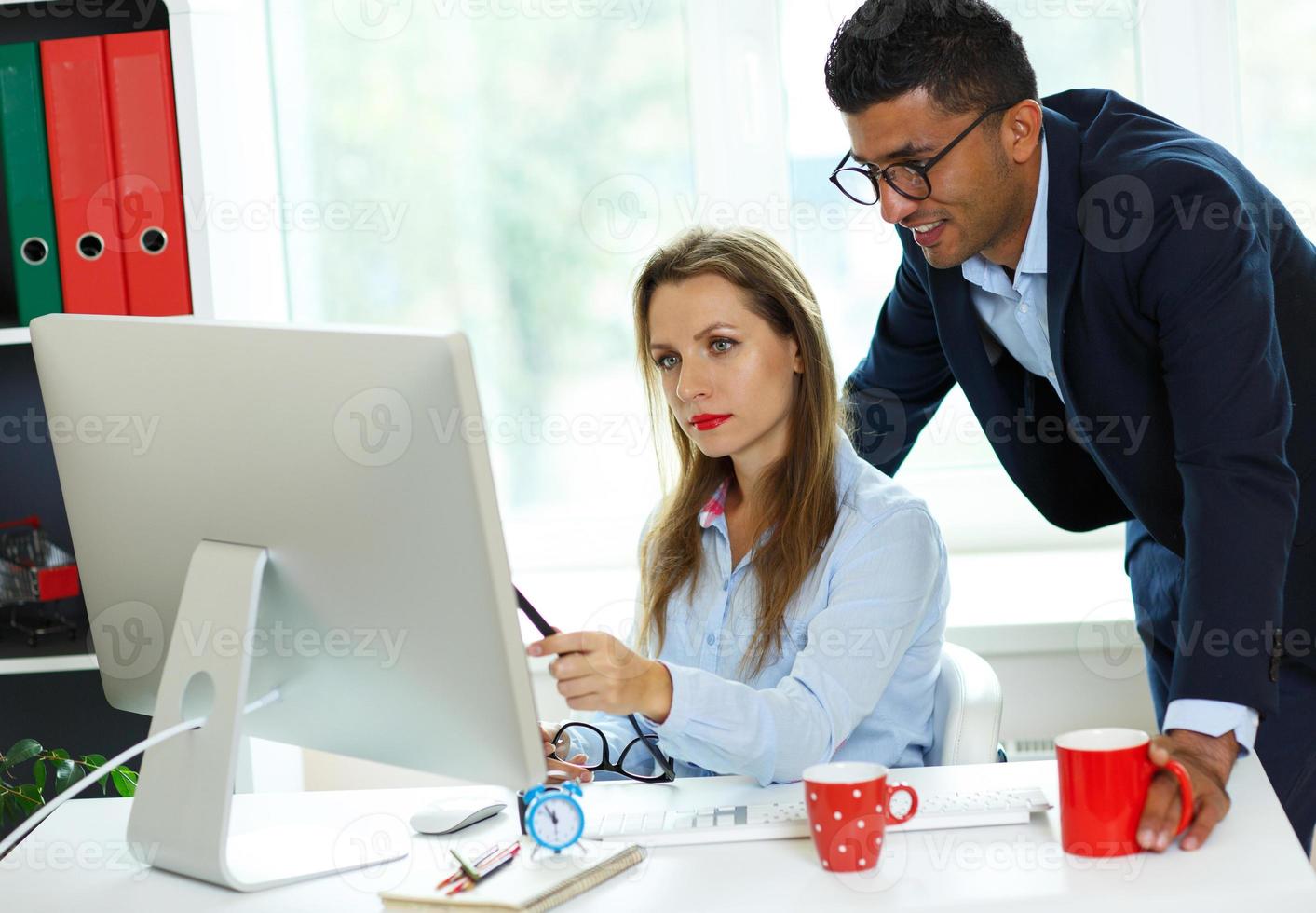 Beautiful young woman and man working from home photo