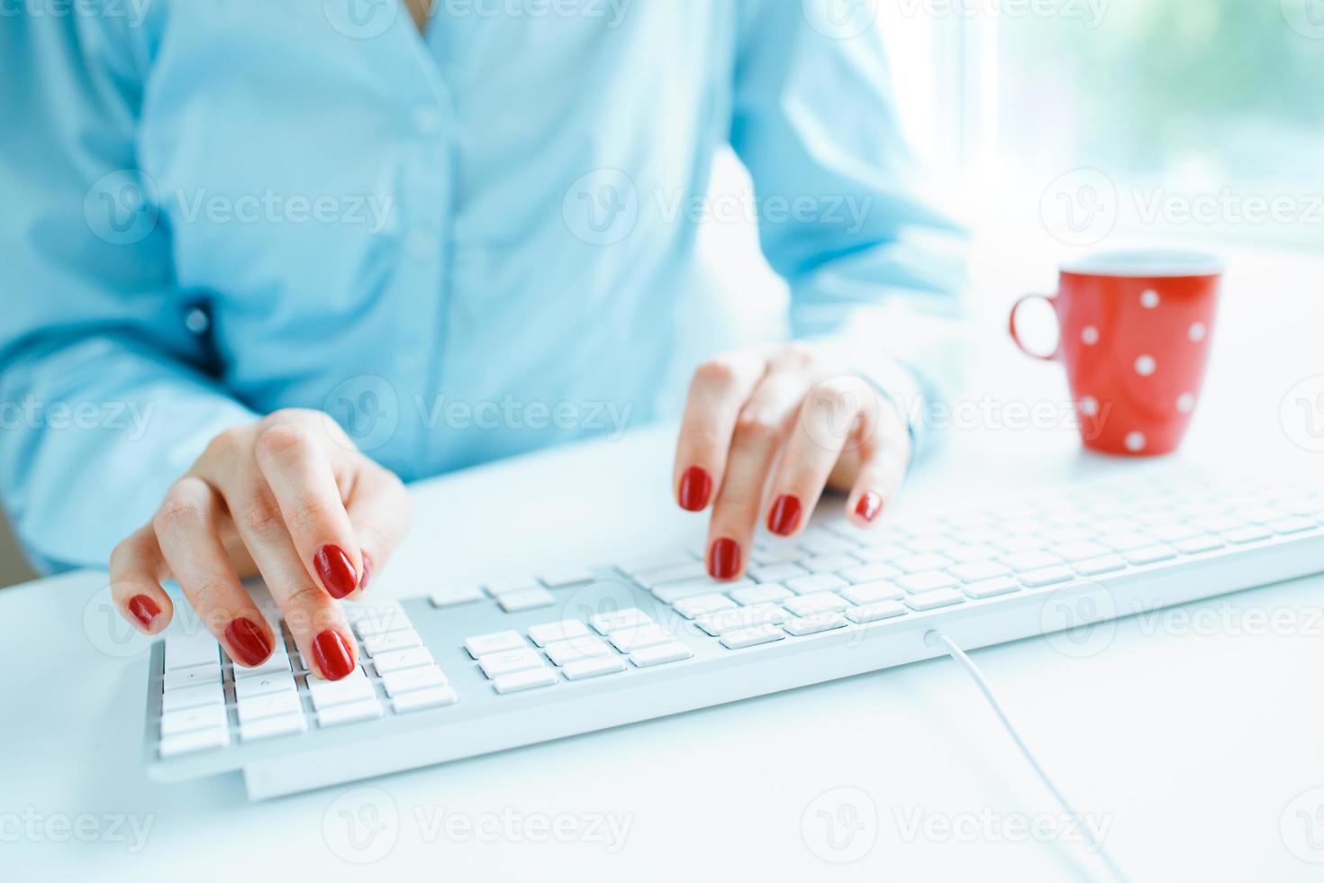 Woman office worker typing on the keyboard photo