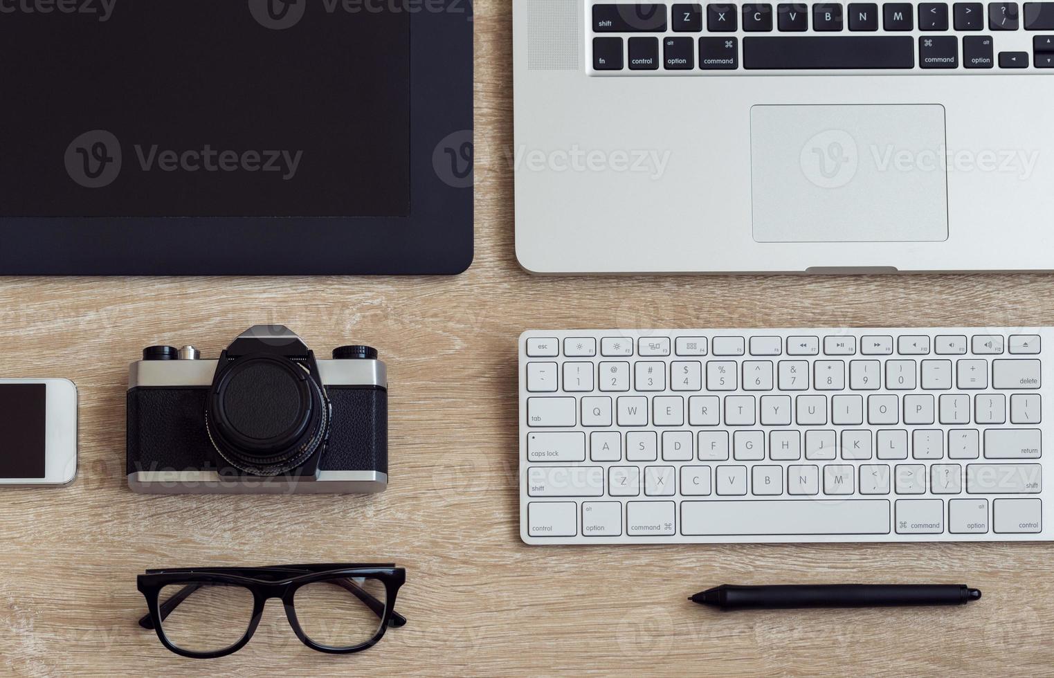 Business workplace with laptop and gadgets on wooden background photo