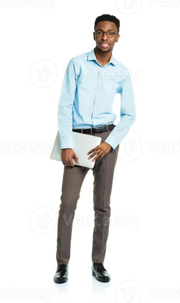 Happy african american college student with laptop standing on white photo