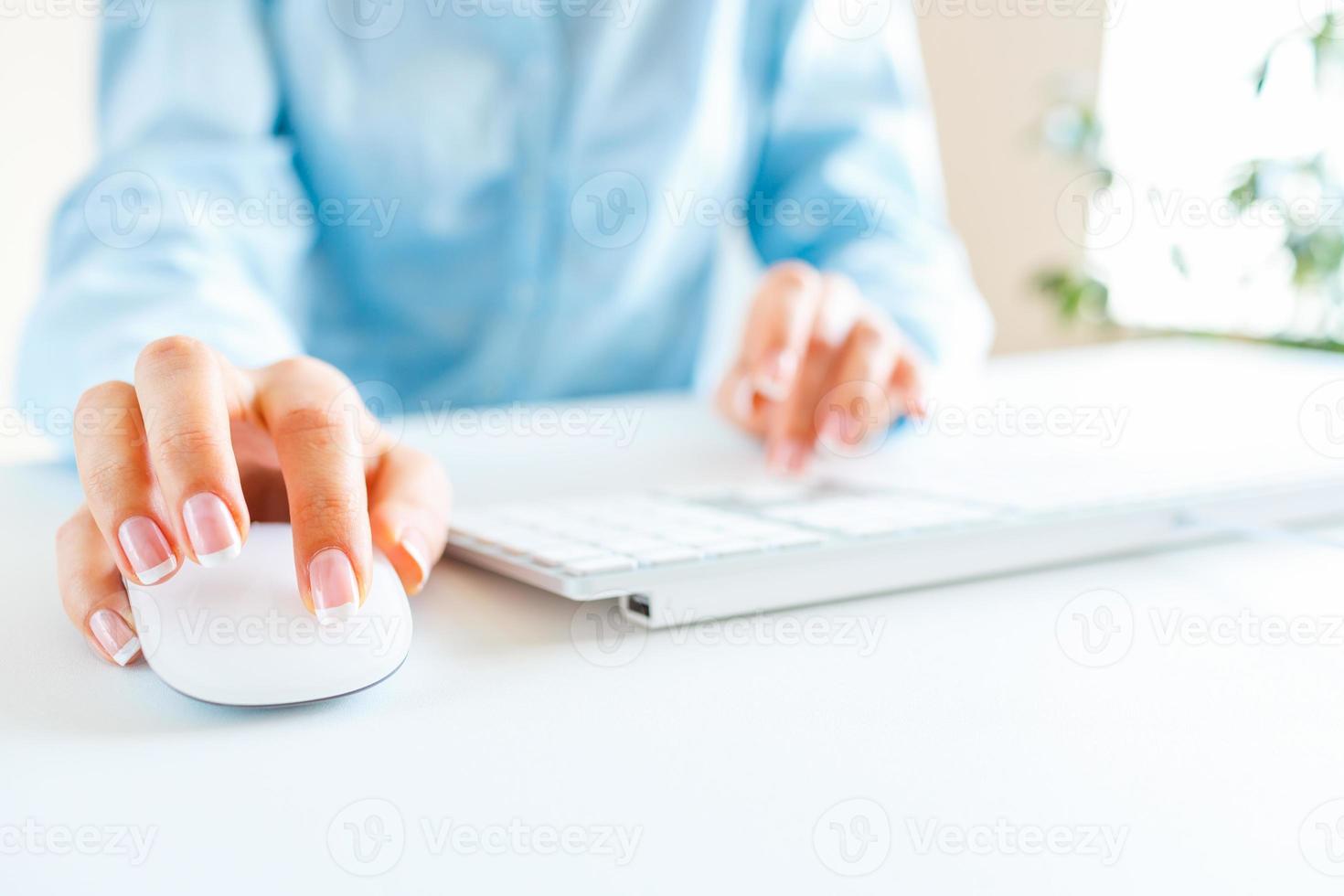 Woman office worker typing on the keyboard photo