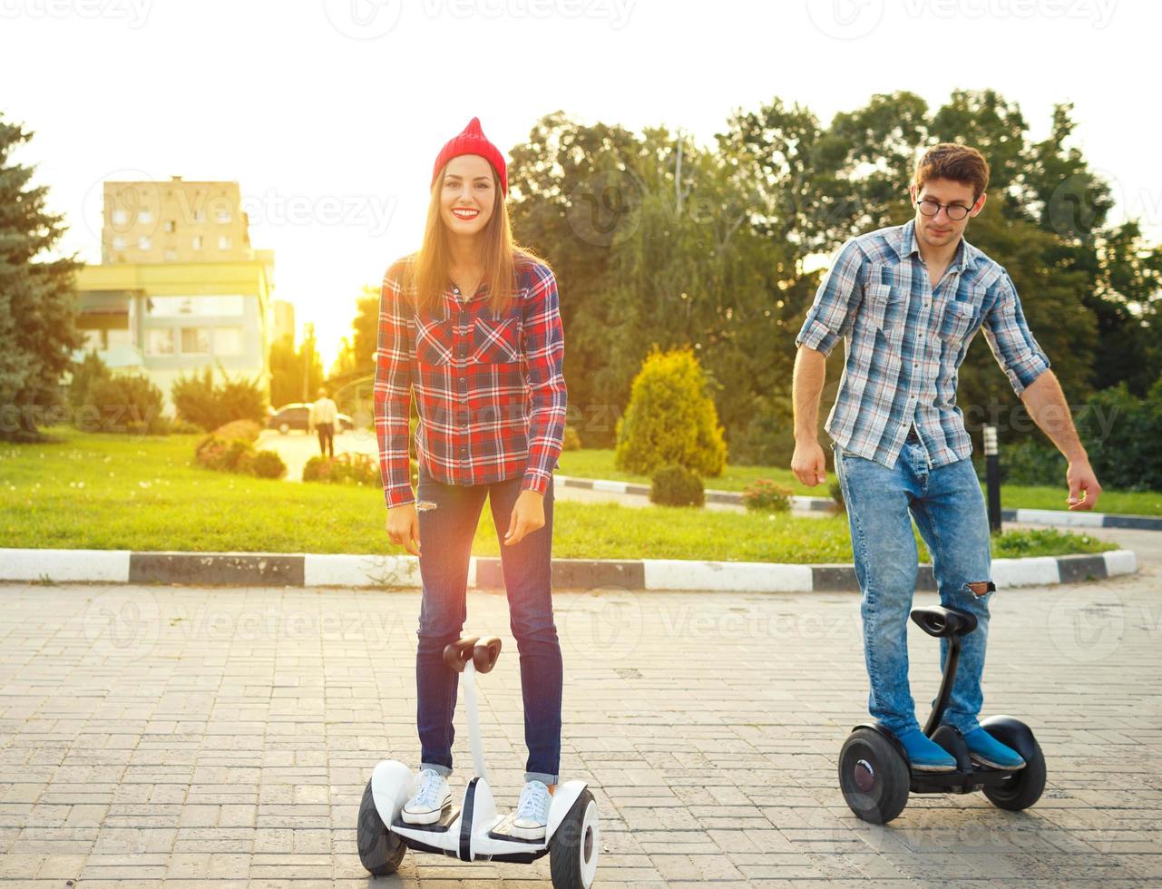 Young couple riding hoverboard photo