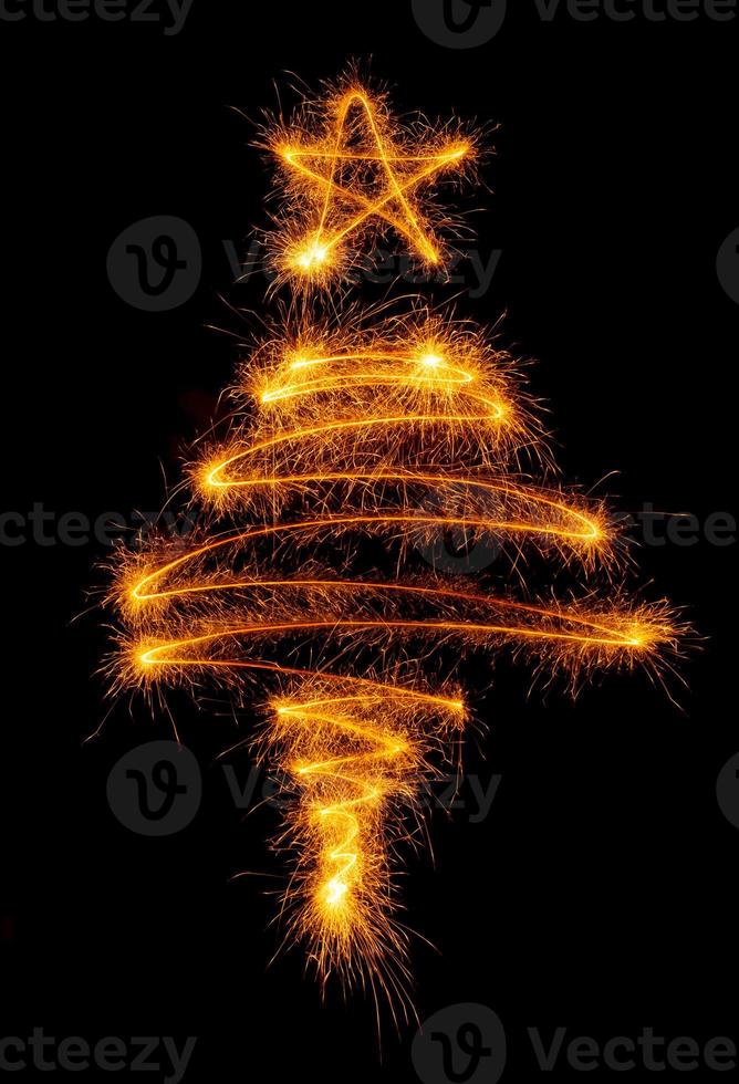 Christmas tree made by sparkler on a black photo