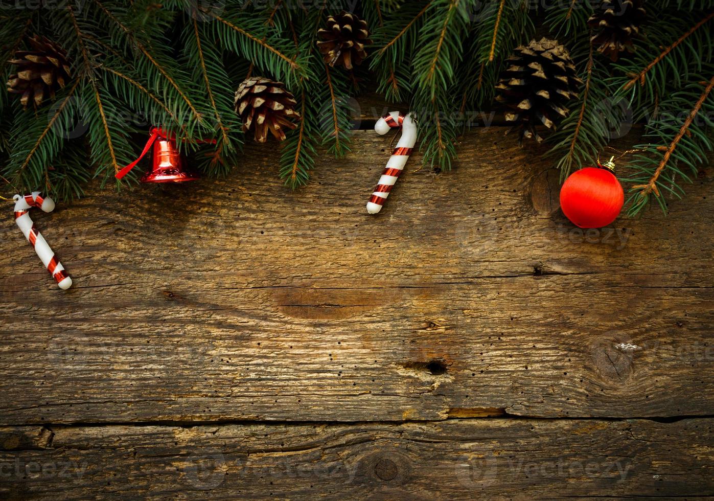 Christmas tree branches with christmas decorations on wooden texture photo