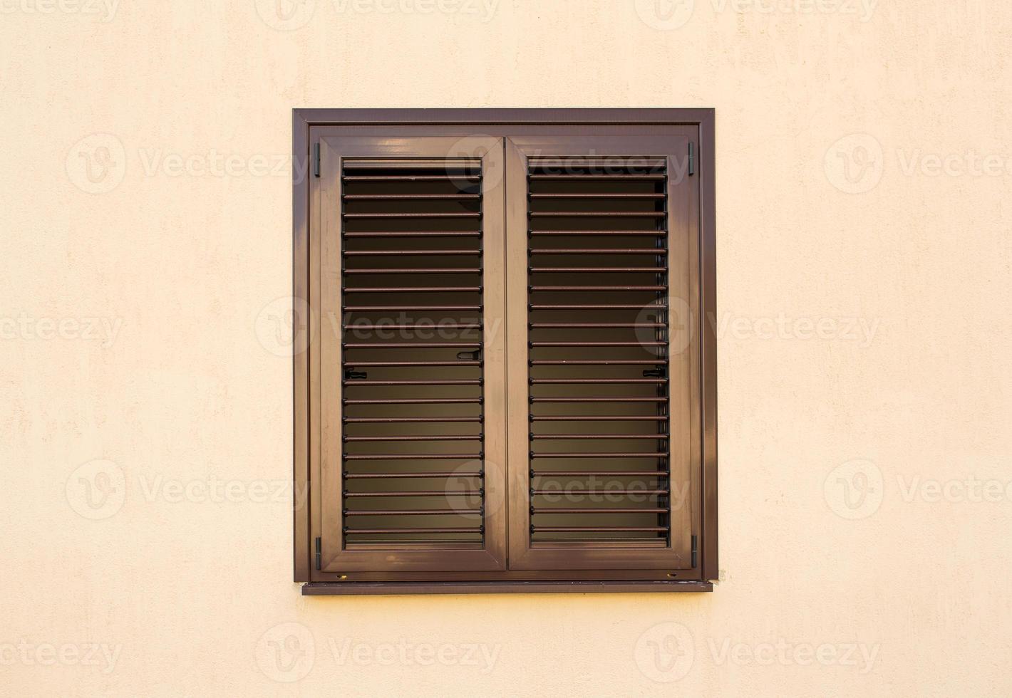 Detail of a window with shutters closed photo
